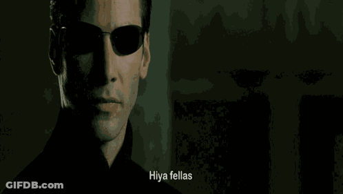 A Close Up Of A Man Wearing Sunglasses With The Words Hiya Fellas Written Below Him GIF