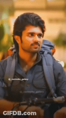 A Close Up Of A Man With A Backpack And The Name Rashmika Gallery On The Bottom Right GIF