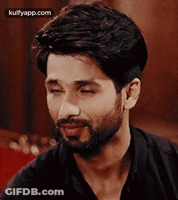A Close Up Of A Man With A Beard And A Black Shirt . GIF