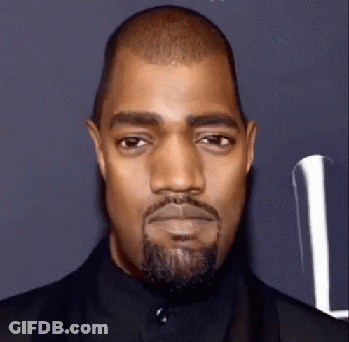 A Close Up Of A Man With A Beard And A Black Suit . GIF