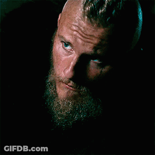 A Close Up Of A Man With A Beard And Blue Eyes Looking At The Camera . GIF