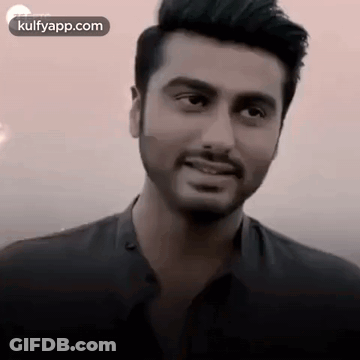 A Close Up Of A Man With A Beard And Mustache Smiling . GIF