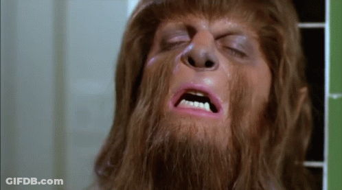 A Close Up Of A Man With A Beard And Pink Lipstick On His Face . GIF