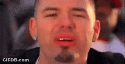 A Close Up Of A Man With A Beard And Red Lips Crying . GIF