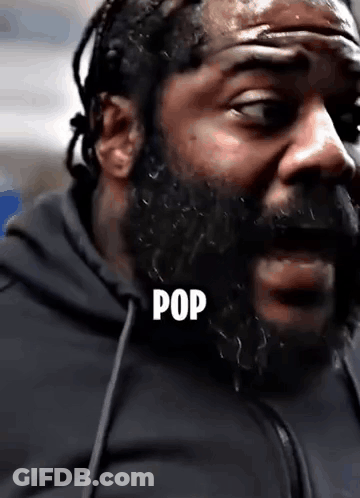 A Close Up Of A Man With A Beard And The Word Pop Written On His Face . GIF