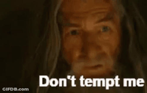 A Close Up Of A Man With A Beard And The Words `` Do N't Tempt Me '' Written On The Bottom . GIF