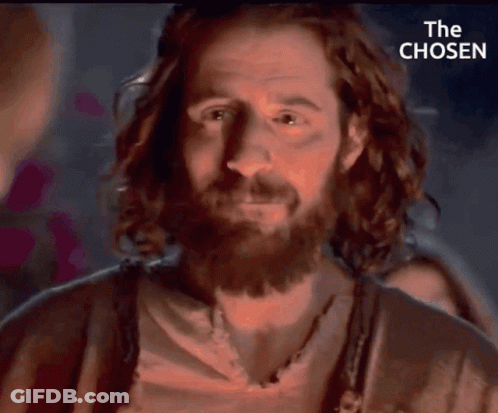A Close Up Of A Man With A Beard And The Words " The Chosen " Behind Him GIF