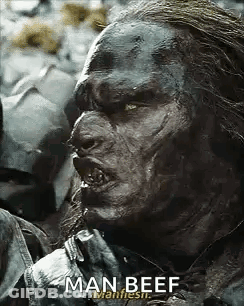 A Close Up Of A Man With A Beard Eating Man Beef . GIF