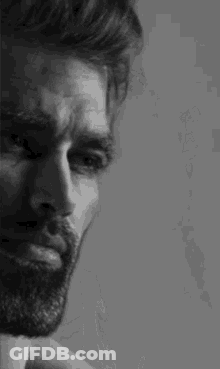 A Close Up Of A Man With A Beard In A Black And White Photo . GIF