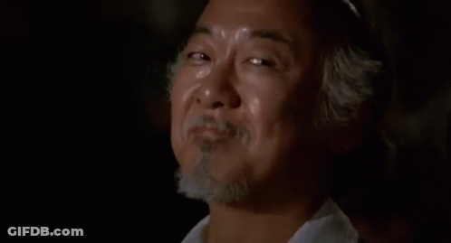 A Close Up Of A Man With A Beard Making A Funny Face In A Dark Room . GIF
