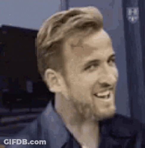 A Close Up Of A Man With A Beard Smiling And Looking To The Side . GIF