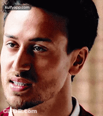 A Close Up Of A Man With A Beard Smiling . GIF