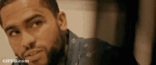 A Close Up Of A Man With A Beard Wearing A Blue Shirt . GIF