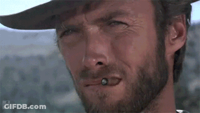 A Close Up Of A Man With A Beard Wearing A Cowboy Hat And Smoking A Cigarette . GIF
