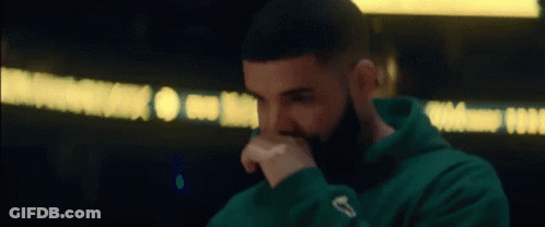A Close Up Of A Man With A Beard Wearing A Green Hoodie . GIF