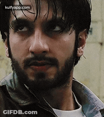 A Close Up Of A Man With A Beard Wearing A Jacket . GIF