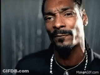 A Close Up Of A Man With A Beard Wearing A Necklace . GIF
