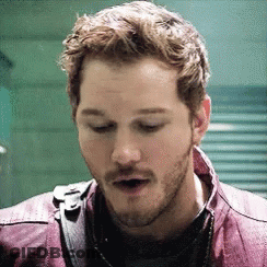 A Close Up Of A Man With A Beard Wearing A Purple Jacket . GIF
