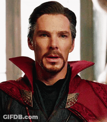 A Close Up Of A Man With A Beard Wearing A Red Cape And A Black Shirt . GIF