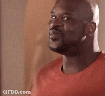 A Close Up Of A Man With A Beard Wearing A Red Shirt And Smiling . GIF