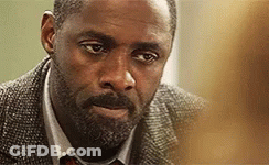 A Close Up Of A Man With A Beard Wearing A Suit And Tie GIF