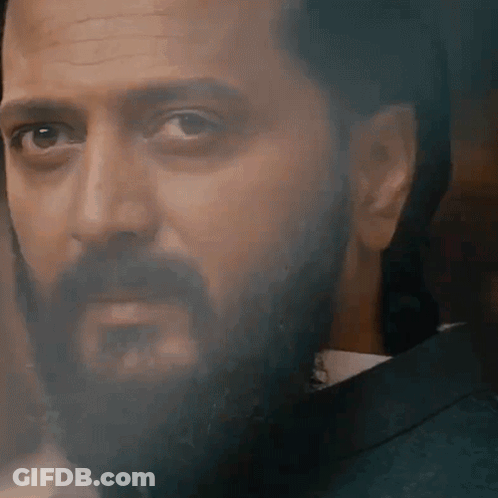 A Close Up Of A Man With A Beard Wearing A Suit And Tie GIF