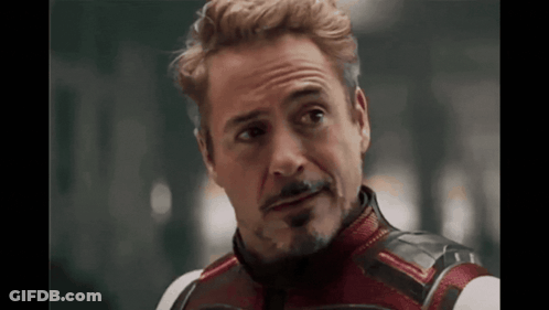 A Close Up Of A Man With A Beard Wearing A Superhero Costume And Looking At The Camera . GIF