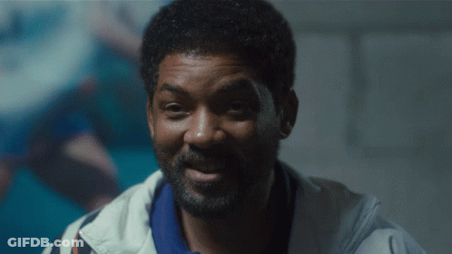 A Close Up Of A Man With A Beard Wearing A White Jacket GIF