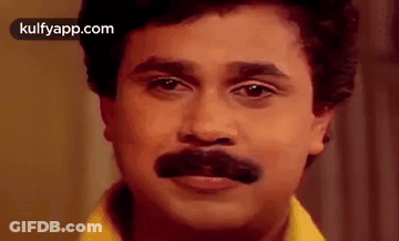 A Close Up Of A Man With A Fake Mustache On His Face . GIF