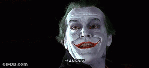 A Close Up Of A Man With A Fake Smile On His Face And The Words `` Laughs '' Written On The Bottom . GIF