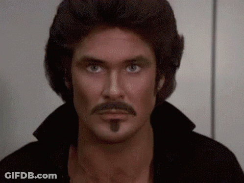 A Close Up Of A Man With A Mustache And A Wig GIF