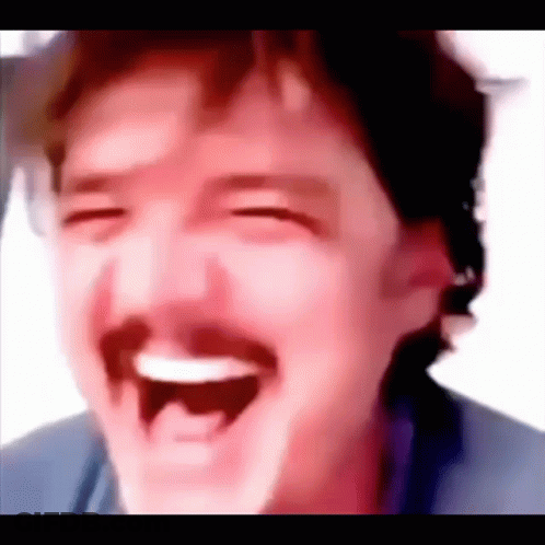 A Close Up Of A Man With A Mustache Laughing With His Eyes Closed . GIF