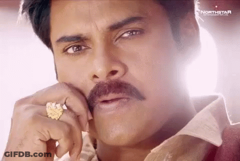 A Close Up Of A Man With A Mustache Wearing A Ring On His Finger . GIF