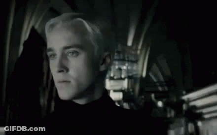 A Close Up Of A Man With Blonde Hair In A Dark Room . GIF