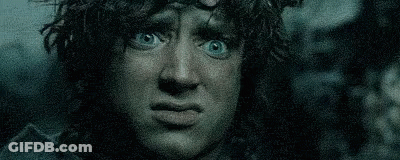 A Close Up Of A Man With Blue Eyes Making A Funny Face In The Dark . GIF