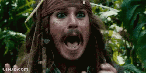 A Close Up Of A Man With Dreadlocks And A Beard Making A Surprised Face . GIF