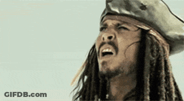 A Close Up Of A Man With Dreadlocks And A Beard Wearing A Pirate Hat . GIF