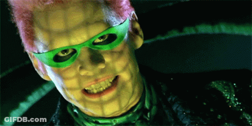 A Close Up Of A Man With Green Glasses And Pink Hair GIF