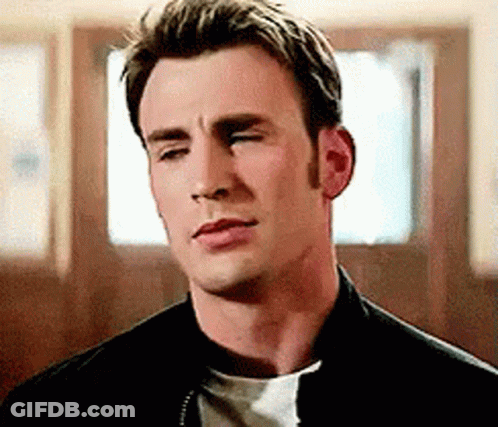 A Close Up Of A Man With His Eyes Closed Wearing A Black Jacket And A White Shirt . GIF