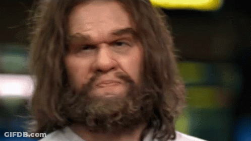 A Close Up Of A Man With Long Hair And A Beard Making A Funny Face . GIF