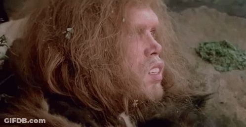 A Close Up Of A Man With Long Hair And A Fur Coat On . GIF
