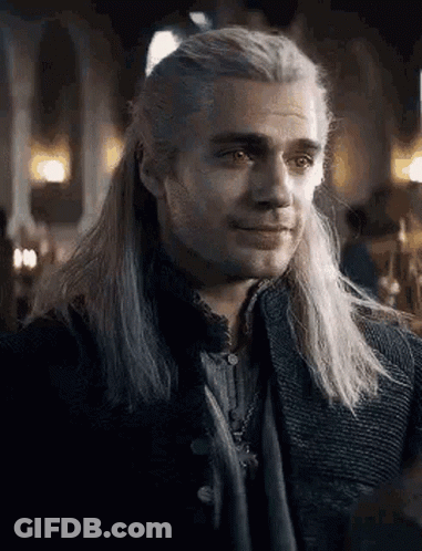 A Close Up Of A Man With Long White Hair Wearing A Black Jacket . GIF