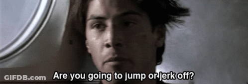 A Close Up Of A Man With The Words Are You Going To Jump Or Jerk Off Written Below Him GIF