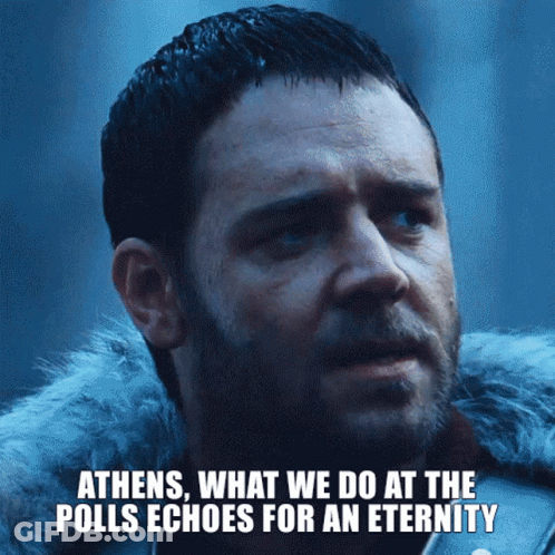 A Close Up Of A Man With The Words Athens What We Do At The Polls Echoes For An Eternity Below Him GIF