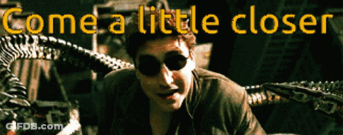 A Close Up Of A Man With The Words " Come A Little Closer " Above Him GIF