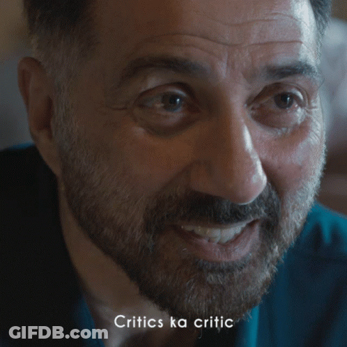 A Close Up Of A Man With The Words Critics Ka Critic Below Him GIF