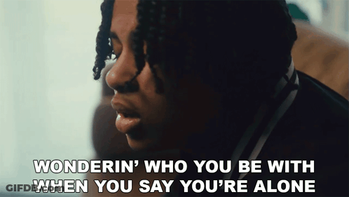 A Close Up Of A Man With The Words Wonderin Who You Be With When You Say You 'Re Alone GIF