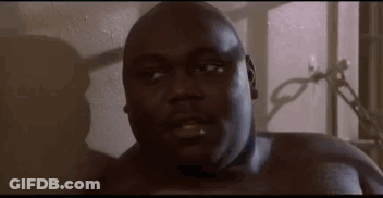 A Close Up Of A Man Without A Shirt Looking At The Camera In A Room . GIF