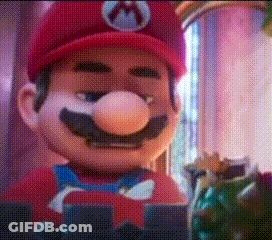 A Close Up Of A Mario Mascot Wearing A Red Hat And A Bow Tie GIF
