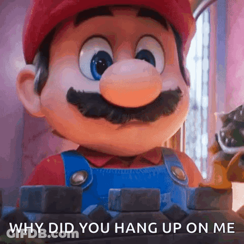 A Close Up Of A Mario Mascot With The Words `` Why Did You Hang Up On Me '' Written On It . GIF